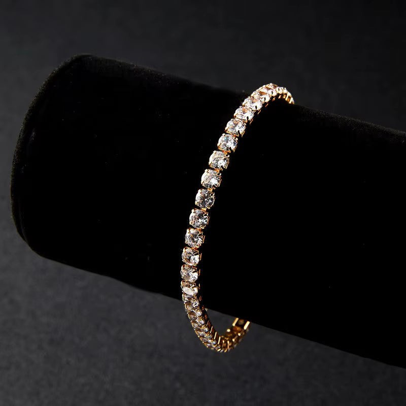 My Store elegant gold-tone tennis bracelet featuring a continuous row of sparkling clear crystals on a black display