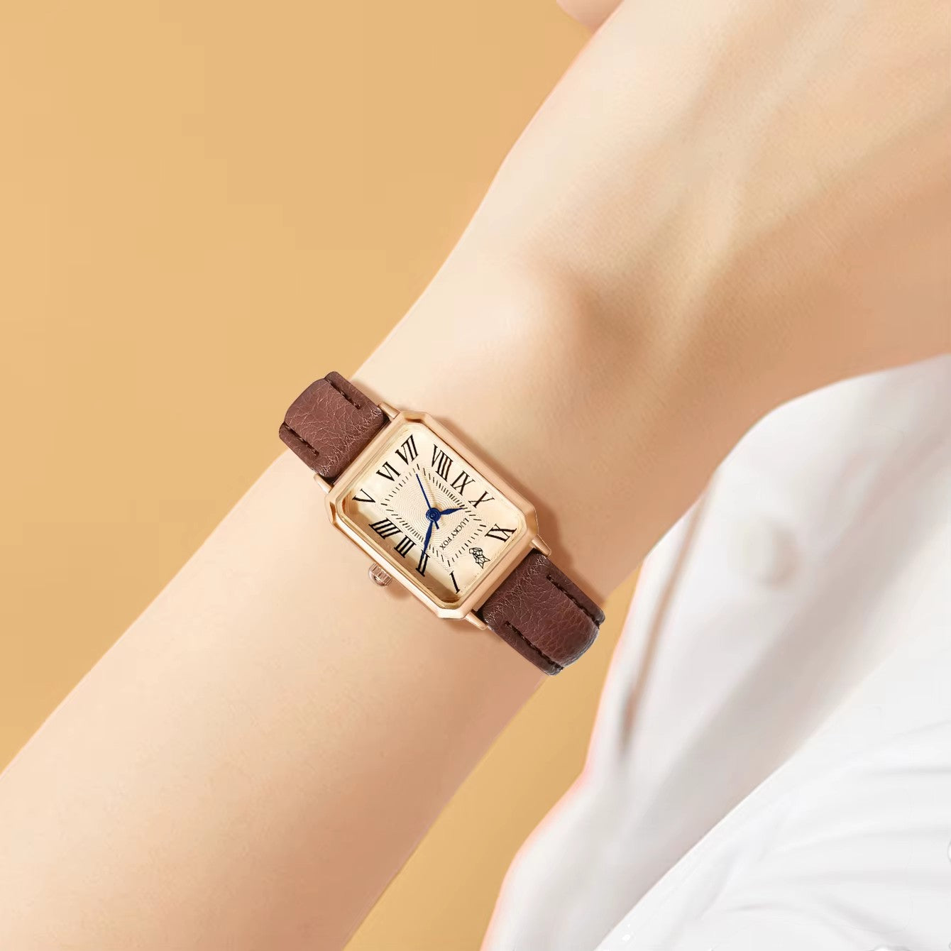 My Store LUCKY FOX rectangular watch with rose gold case, cream dial, Roman numerals, and brown leather strap on wrist