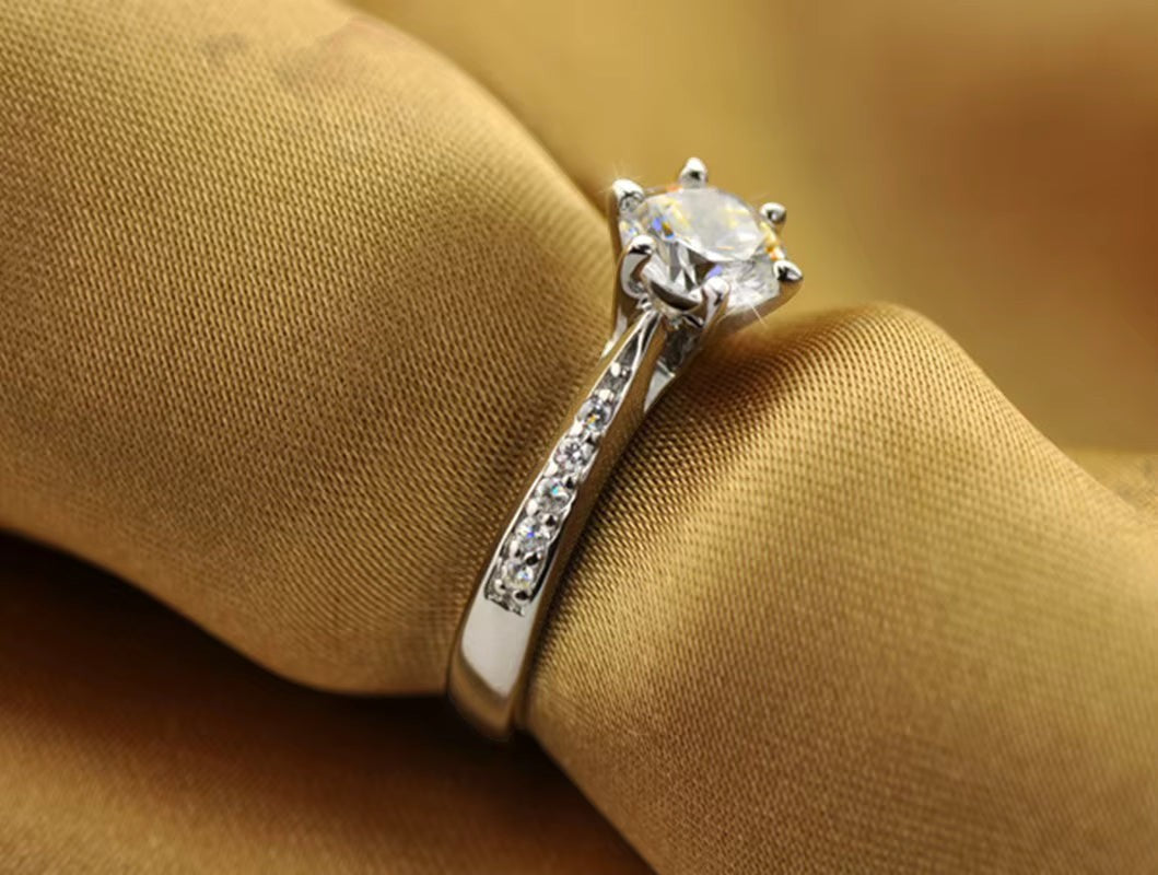 My Store solitaire engagement ring with a brilliant center stone, six-prong setting, and pavé accented silver band.