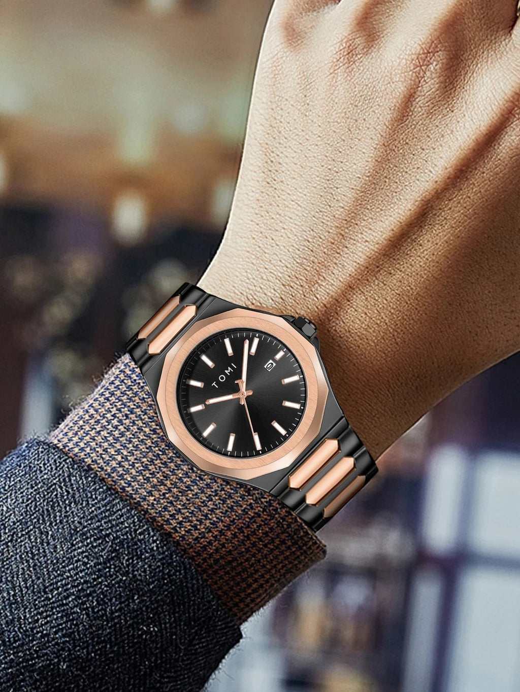 My Store TOMI luxury stainless steel wristwatch in black and rose gold worn on a man's wrist
