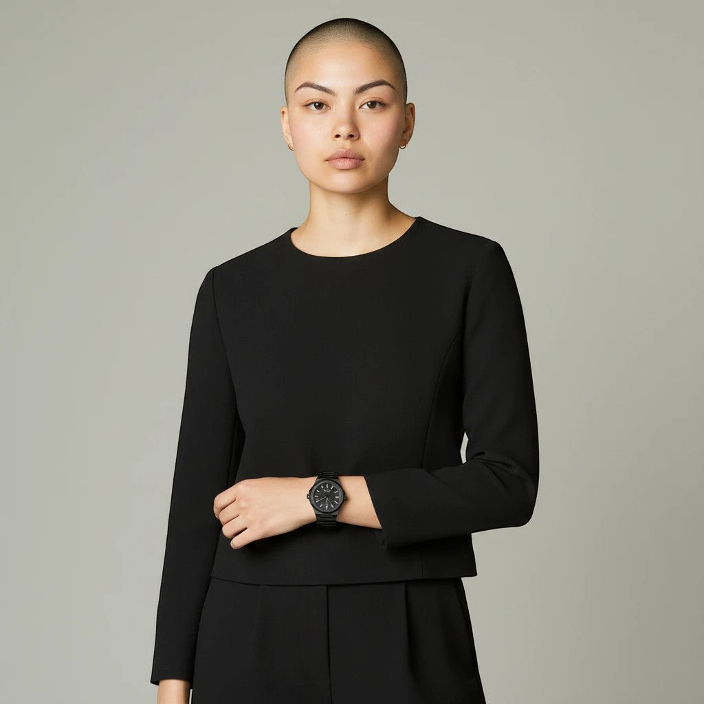 My Store TOMI luxury all-black stainless steel wristwatch worn by a model in a black top against a neutral background