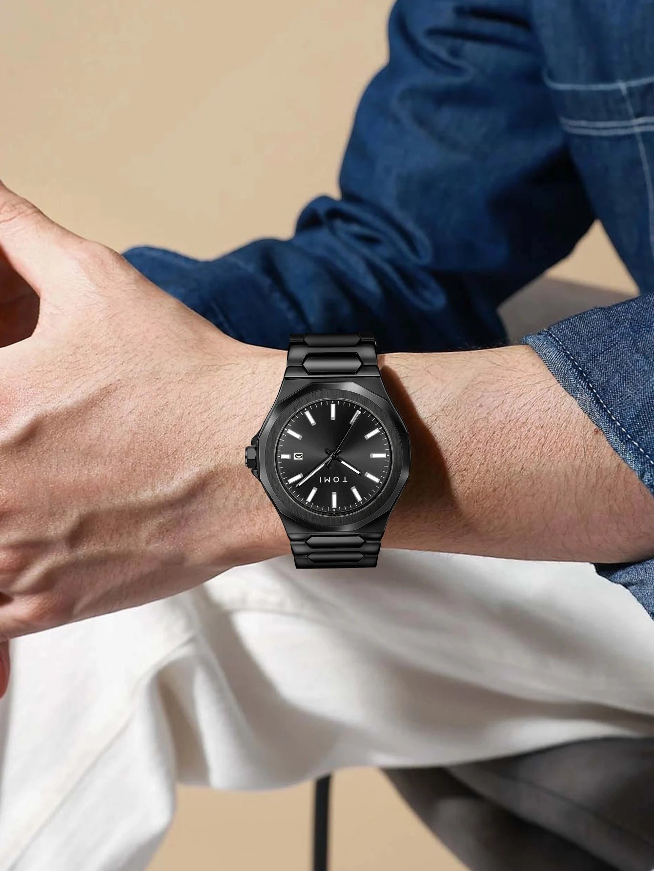 My Store TOMI luxury all-black stainless steel wristwatch with minimalist dial worn on a man's wrist