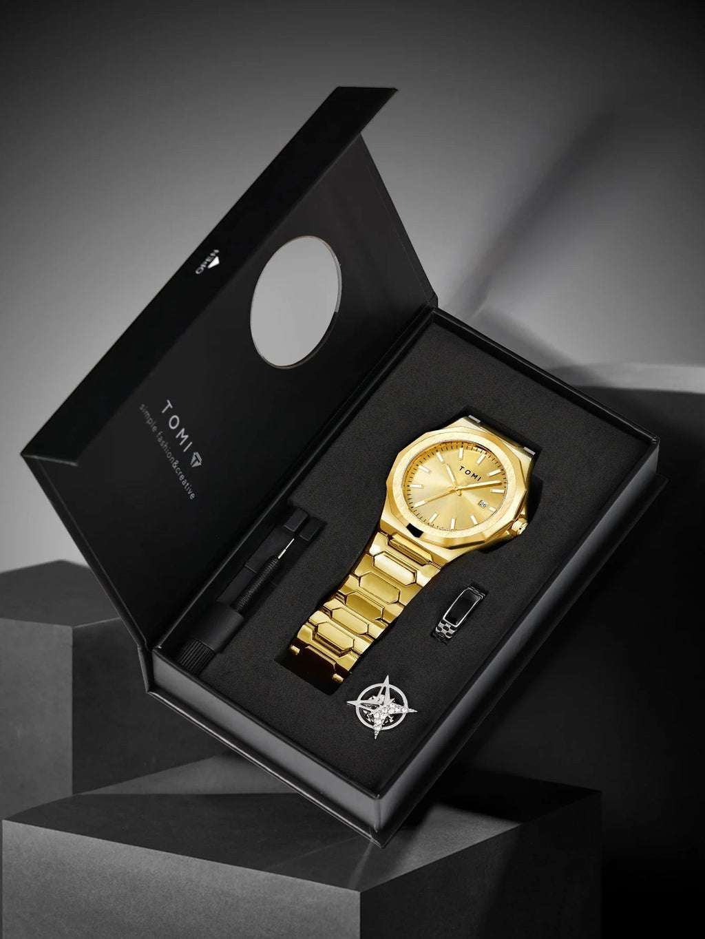 My Store TOMI gold stainless steel wristwatch gift set with matching ring and link tool in a presentation box.