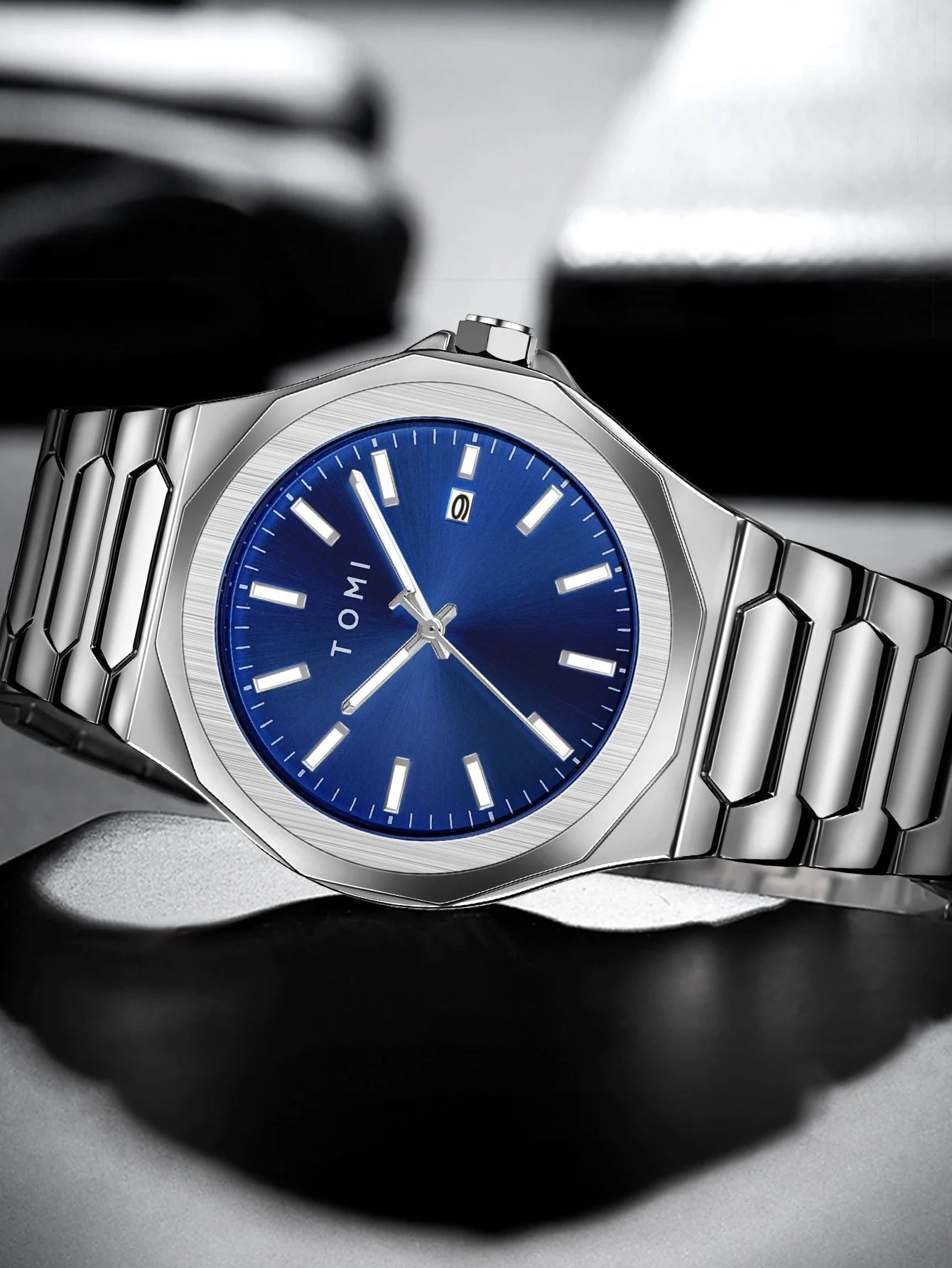 My Store TOMI luxury stainless steel wristwatch with a blue sunray dial and silver link bracelet.