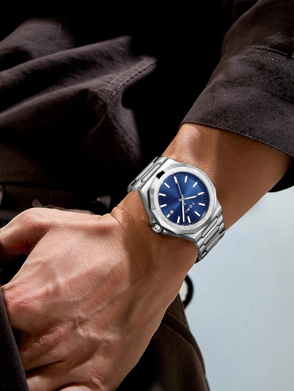 My Store TOMI luxury stainless steel wristwatch with a blue dial worn on a man's wrist